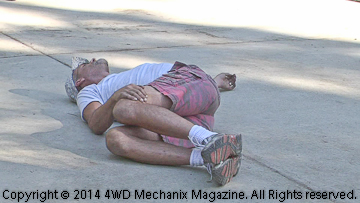 Volunteer 4x4 driver Jake Munoz stretches before Rubicon Trail day.