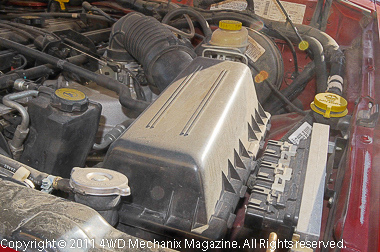 The air box is easy to locate on this Jeep XJ Cherokee, similar to the Wrangler air boxes.