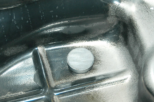 Magnet in oil pan for picking up debris; clean and install properly.