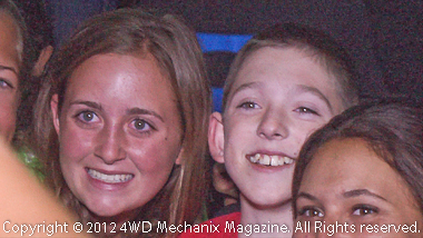 Camp Wamp Kid (center) surrounded by enthusiast staff at the dance.