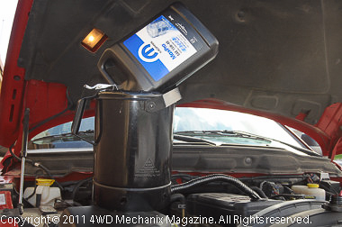 Gallon bottles and a 5-quart filler can speed fill of the three gallon capacity 5.9L diesel with a new filter.