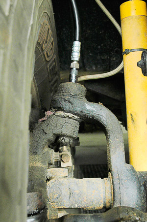 Greasing upper steering knuckle ball joint.