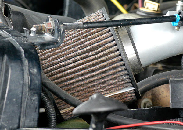 Aftermarket, low-restriction air filter and intake tube.