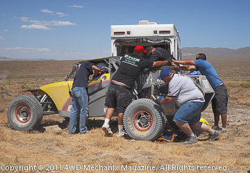 Pit Two action as a crew in the remote desert races to get the car back into action!