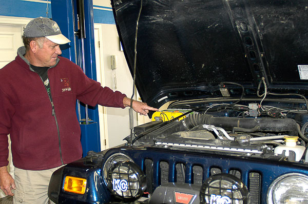 Student assesses his Jeep's battery.
