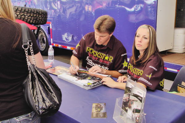 Rob MacCachren signs posters at 2011 Off-Road Expo