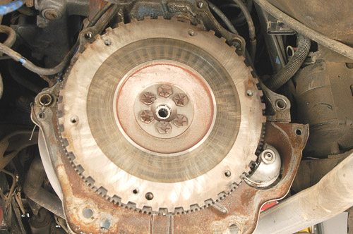 Inspecting a clean Jeep flywheel for damage.