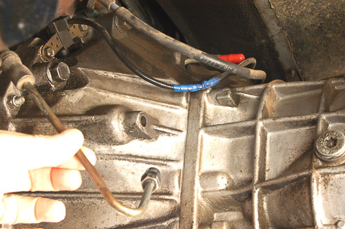 Draining hydraulic brake fluid from clutch release lines.