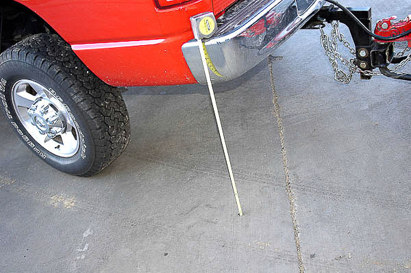 Adjusting torsion bars for leveling tow vehicle chassis.